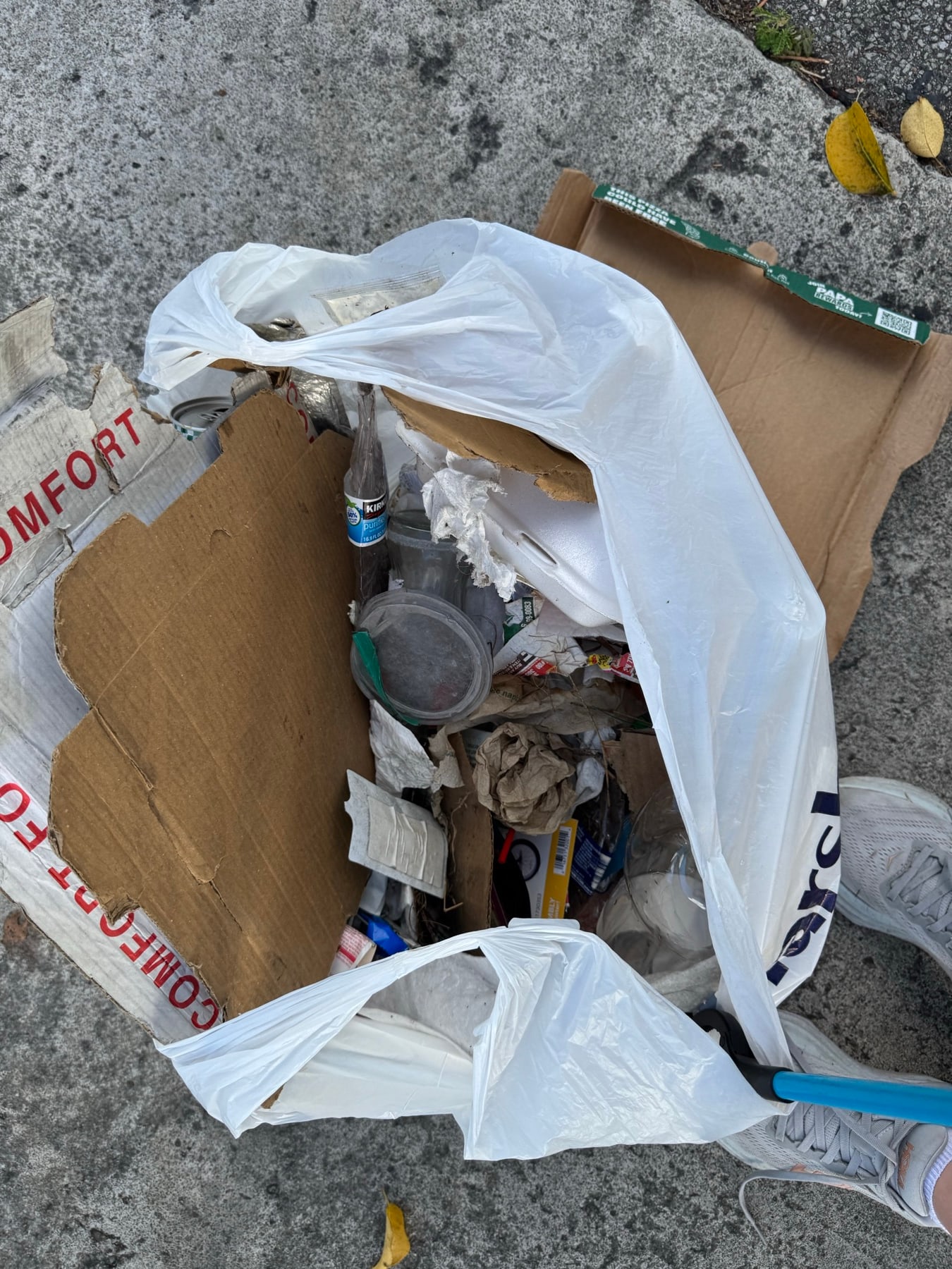 A bag of bottles and cans picked up off the sidewalk
