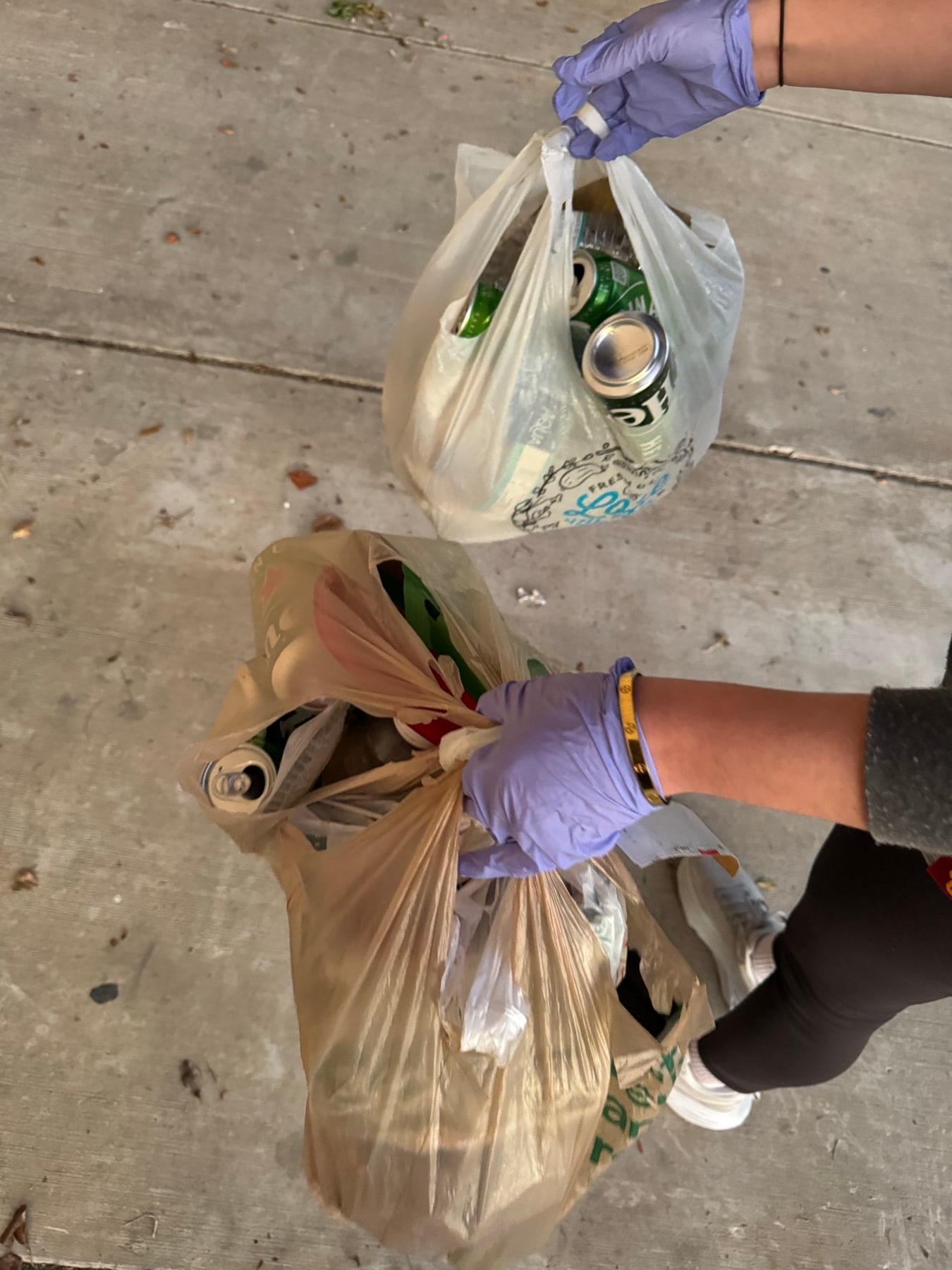 Two bags of bottles and cans ready to be recycled